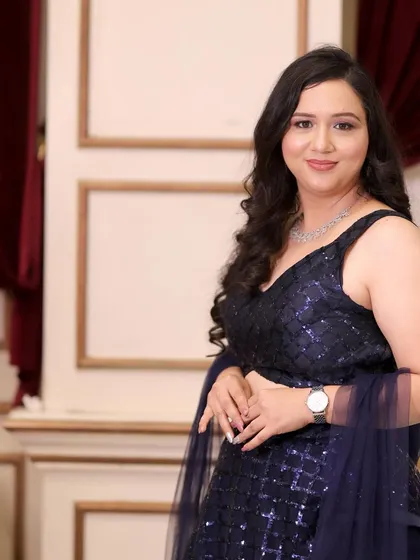 A sophisticated party makeup look in a navy blue gown. The makeup is elegant and understated, perfect for a formal event.