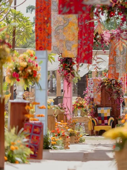 A peek through the entrance of the 'Rajasthani Folklore' Mehendi, with hanging fabrics framing the view.