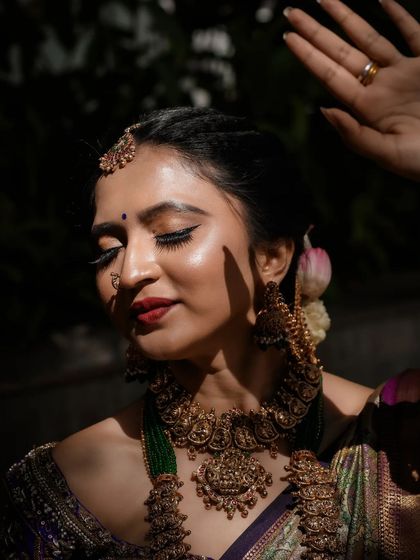 A close-up artistic shot focusing on the makeup and the intricate temple jewellery, which pairs perfectly with the traditional outfit.
