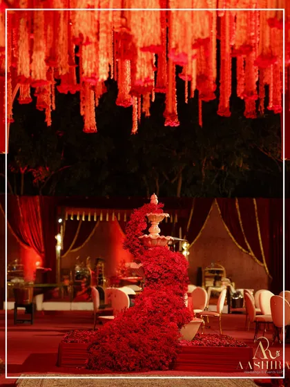 A framed view of the magnificent red rose fountain, highlighting its role as the stunning centerpiece of the entire event space.