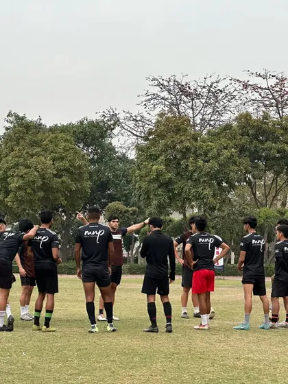 The only time we use the word "never" is "never give up." Our senior team in a huddle during training, united and focused on their goals.