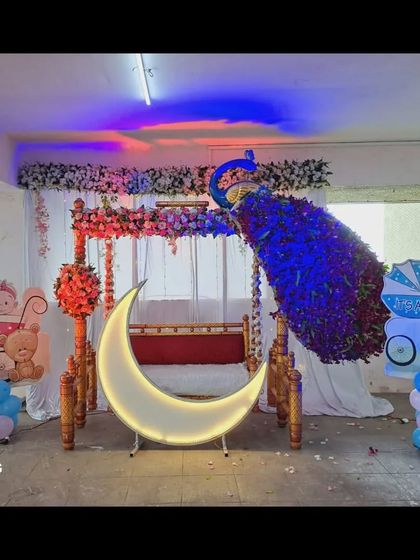 The outdoor baby shower decoration with colorful lighting effects, transforming the space into a festive party area.