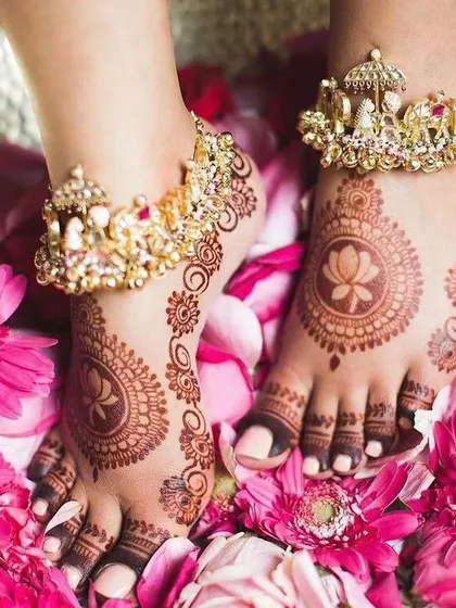 Your bridal look isn't complete without beautiful foot mehndi. This design features a delicate lotus mandala on the top of the feet, with intricate patterns extending to the toes, perfectly complementing any bridal footwear.