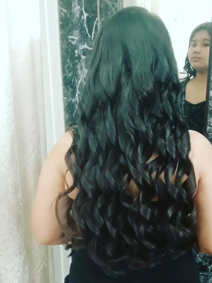 A full head of long, cascading curls, showing off incredible volume and texture. This is a perfect look for someone who wants maximum glamour.