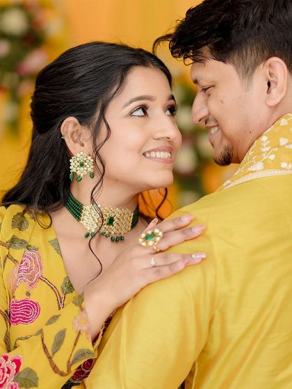 A close-up portrait from Shivangi and Aakash's Haldi, capturing the loving gaze they share.