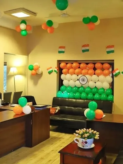Here is a full office decoration I did for Independence Day. The main feature is a large backdrop of the Indian flag made entirely of saffron, white, and green balloons, complete with a printed Ashoka Chakra in the center. I also added smaller balloon clusters and flag bunting throughout the room.