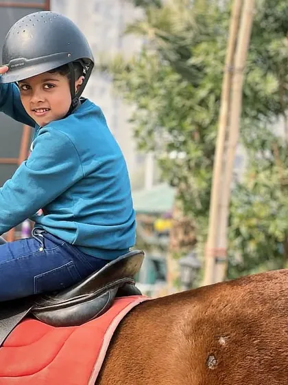 A young boy flashes a peace sign, full of excitement during his ride. We love capturing the pure fun kids have at our club.