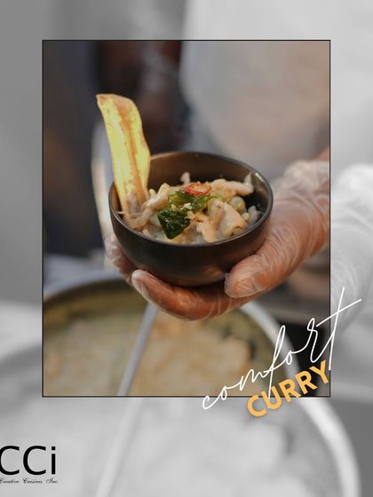 Comfort in a bowl. A member of our service team presents a warm, comforting curry, garnished with a crispy wafer. This dish is perfect for creating a cozy and satisfying experience, especially during cooler weather.