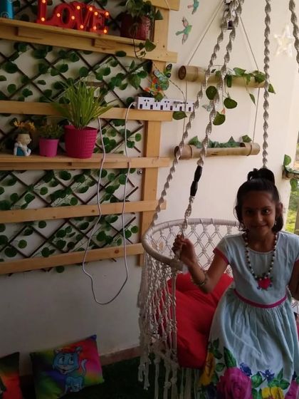 A happy little client enjoying her new macrame swing. We designed this balcony to be a fun and colorful space for the whole family.
