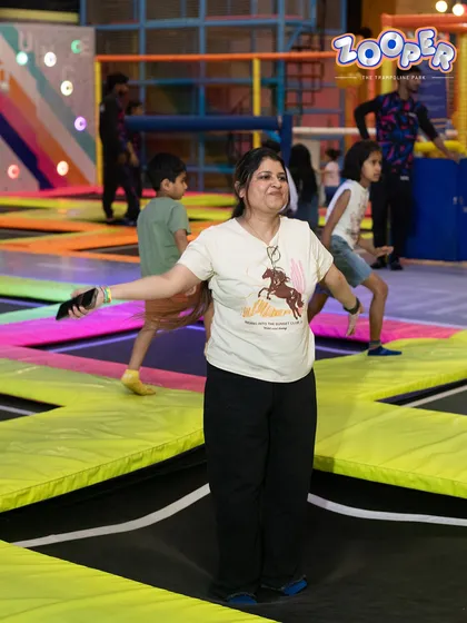 Finding your balance and your smile. A guest enjoys the wide-open space of our main trampoline court.