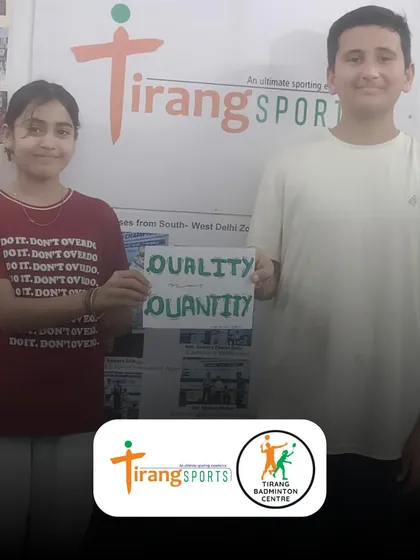 Two of our students proudly display their poster illustrating our "Quality not Quantity" philosophy. It's amazing to see them internalize the core values we teach.