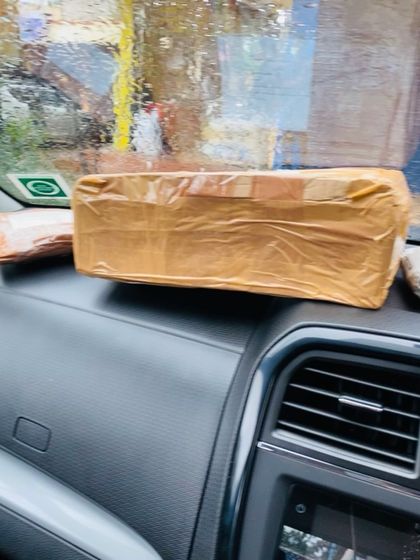 A securely wrapped package on the dashboard, ready for the post office. I take pride in getting my products to you safely.