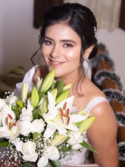 A happy and radiant Nisha, her smile lighting up the frame. A perfect example of a simple yet beautiful bridal look.