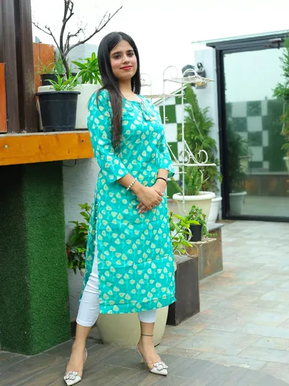 A bright and cheerful shot for the Afsana collection. The vibrant color of the kurta stands out against the fresh greenery, creating an appealing image for online shoppers.