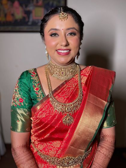 A full-body shot showcasing Pooja's complete, stunning South Indian bridal look.