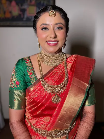 A full-body shot showcasing Pooja's complete, stunning South Indian bridal look.