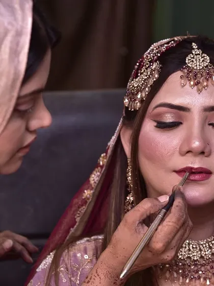 A close-up of the lipstick application process for the engagement bride.