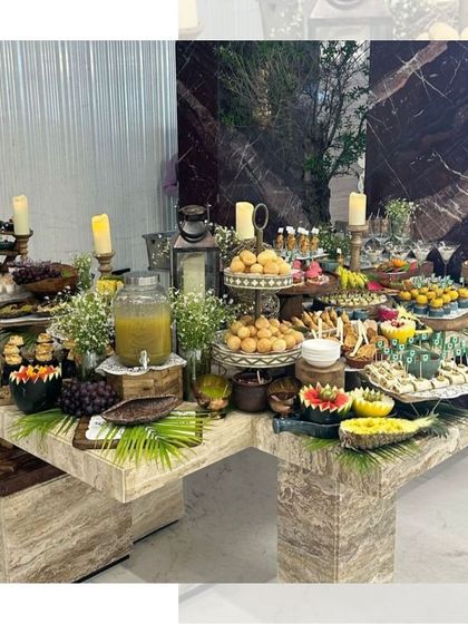 A stunning grazing table set up on a marble countertop. This image captures the luxury and abundance of our service, with a wide variety of snacks, fruits, and desserts beautifully arranged.