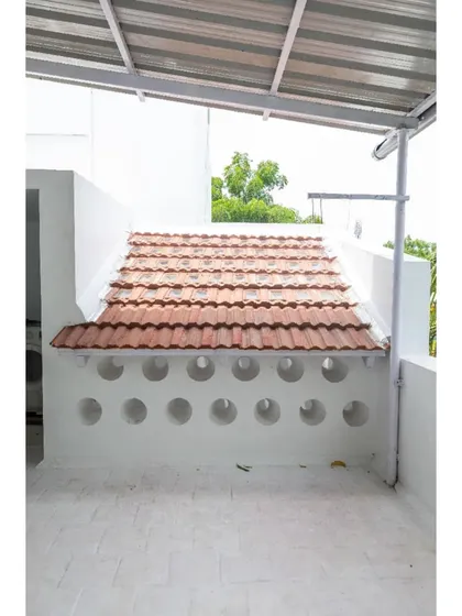 The 'House of No Windows' in Tirunelveli uses unconventional methods like these perforated roof tiles to bring in light and air while maintaining privacy.