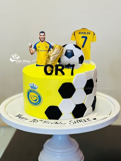 A cake for a Cristiano Ronaldo fan. This design features the Al Nassr FC kit colors, the team logo, and a topper of CR7 himself.