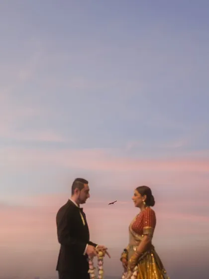 A minimalist and poetic shot of the couple during their sunset ceremony. A single bird flies between them, adding a touch of serendipitous magic to this beautiful moment.