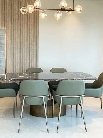 The dining room is where memories are made. For this space, I selected elegant seating and a beautiful chandelier to create a bright, youthful aura, ensuring every family gathering is complemented by comfort and style.
