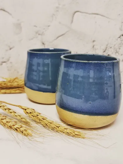 A pair of my blue ceramic tumblers. These can be safely used in dishwashers and microwaves, but I always recommend handling them with care to ensure they last.