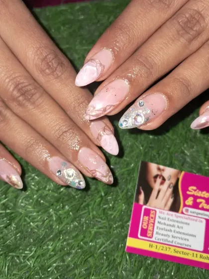 A soft and pretty design with a pink marble base, gold accents, and large, eye-catching stone clusters.