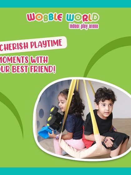 Best friends sharing a swing in our sensory play area. We provide a gentle and fun environment for toddlers to play together.