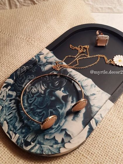 Our XL trinket tray in a stunning ocean-inspired design, with a deep navy blue and a swirling white marble effect.