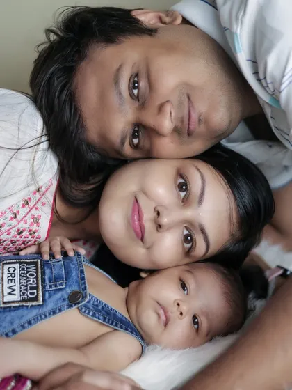 A sweet family portrait from above. Lying down together creates a relaxed and intimate setting, allowing me to capture the loving expressions of the new parents as they gaze at their baby.