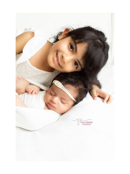 The sweet bond between sisters, starting from day one. Capturing the gentle curiosity and love of an older sibling is one of the most special parts of my job.