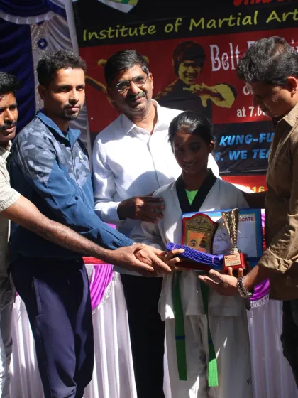 Hard work pays off. This is a proud moment for one of my students as she is awarded her new belt and a trophy during our official belt examination ceremony. Every belt is earned through dedication.