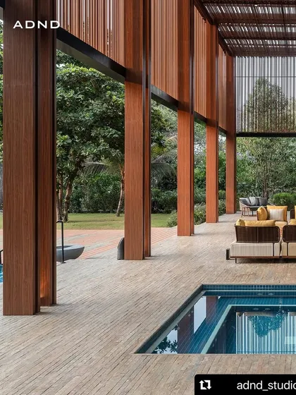This unique design incorporates a plunge pool directly into the wooden deck of the veranda. It's an unexpected feature that adds a touch of playfulness and luxury to the outdoor living space.