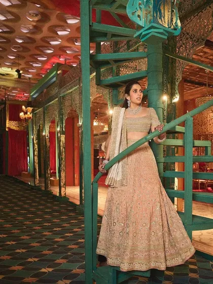 This peach Abu Jani Sandeep Khosla lehenga is all about understated elegance. The intricate chikankari work and classic silhouette make it a timeless piece for any wedding event.