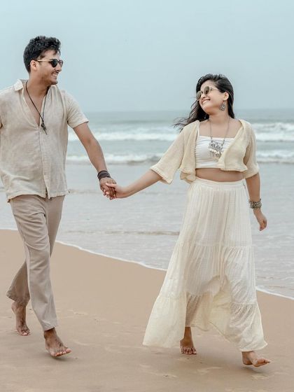 A happy, candid moment of the couple walking hand-in-hand on the beach in Goa. Their smiles and easygoing body language reflect the comfortable and fun atmosphere I strive to create during my shoots.