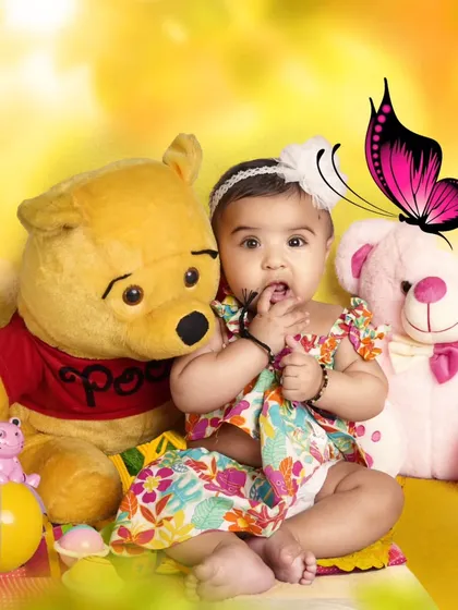 A sweet toddler portrait with her teddy bears. The warm, yellow background and butterfly edit add a whimsical feel to this photo.