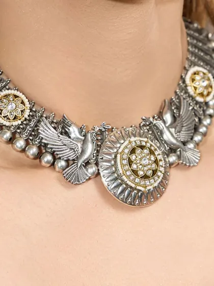 A model wearing the 'Mystic Wings' choker, showcasing how the piece sits gracefully on the collarbone, making a subtle yet powerful statement.