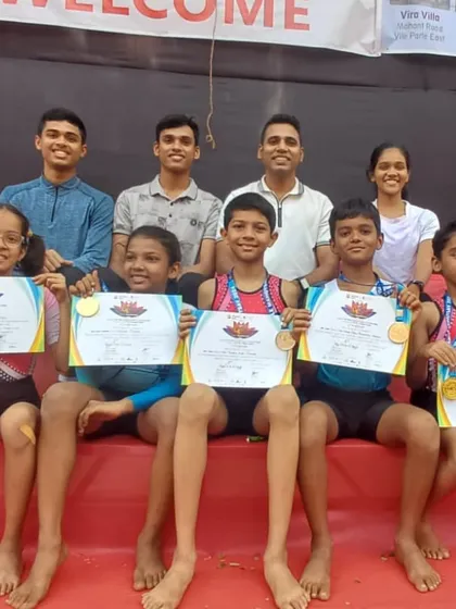 The joy of victory. Our young champions and coaches proudly display their medals and certificates after a successful run at the Parle Mahotsav. We believe in celebrating every achievement, big or small, as a team.