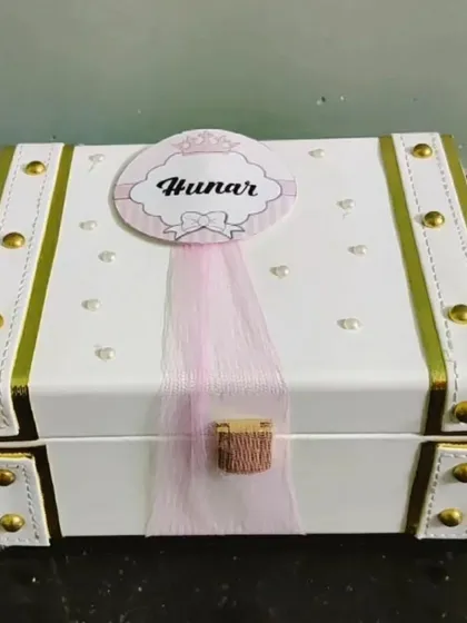 A classic white and gold personalized trunk for a sister named Hunar. These trunks are perfect for storing keepsakes long after the gifts are enjoyed.