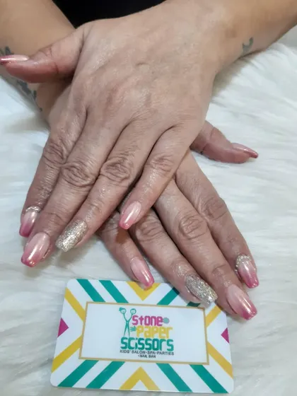 A sophisticated set featuring a pink chrome base with a full-coverage gold glitter accent nail. The combination of chrome and glitter creates a rich and luxurious texture.