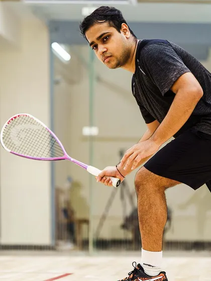 An action portrait of 20-year-old Yash Salunkhe, poised and ready for the next shot. The intensity in his gaze shows the competitive spirit of the Goan team's dynamic duo.