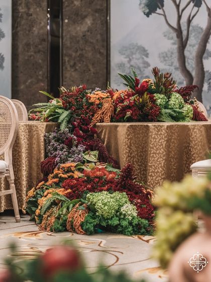 A floral runner cascades down the side of a table at the 'Orchard of Life' naming ceremony, blending seamlessly with the surrounding decor.