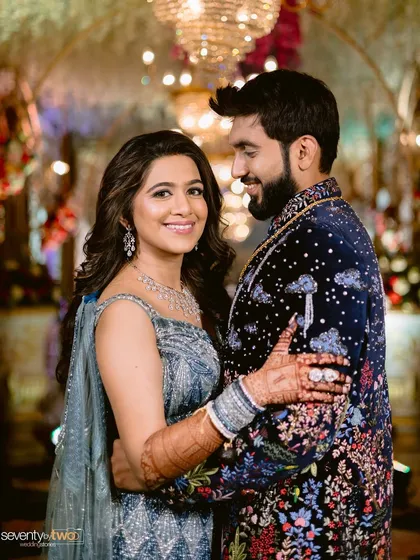 Your reception look is a chance to shine. For this glamorous evening event, we chose a sophisticated makeup style with soft waves that complemented her stunning modern blue lehenga, creating a look that was both chic and celebratory.