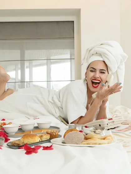 A moment of pure joy captured during the hotel shoot. The model's laughter while on the phone creates a highly engaging and relatable image.
