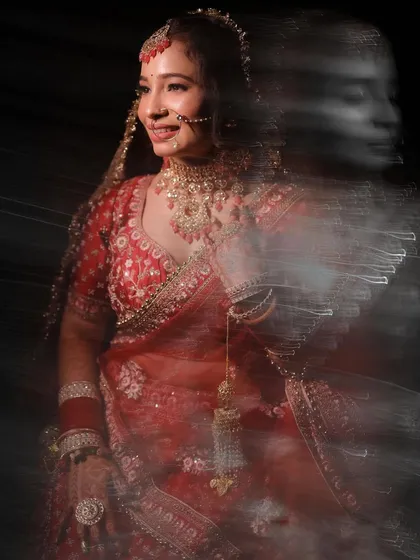 A creative bridal portrait using a slow shutter speed to create a beautiful motion blur effect, capturing the bride's joyful movement.
