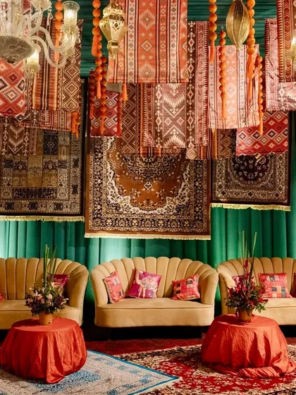 Creating cozy, luxurious spaces for guests is key. For this Moroccan-themed event, I designed a lounge area with plush seating against a backdrop of intricately patterned hanging rugs and warm, ambient lighting.