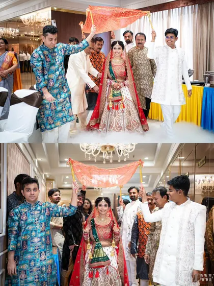 The bride's grand entrance under a delicate phoolon ki chadar, a classic and beautiful moment in an Indian wedding.