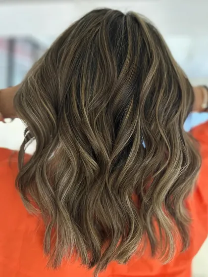 Hello summer. This beach blonde balayage on a textured, mid-length cut is ready for sun and waves.