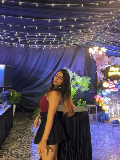 A side profile in the red top and black skirt. This shows how the outfit looks from a different angle.